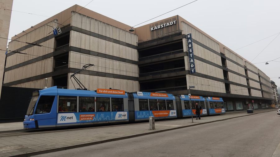 A blue MVG tram waiting at a stop on Bahnhofplatz near Munich's main railway station