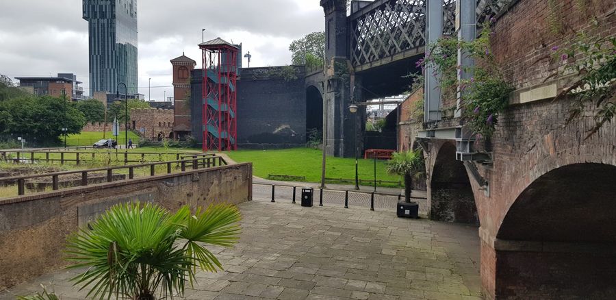 Castlefield in Manchester, where reconstructed Roman fort walls, Victorian railway viaducts and the modern Beetham Tower meet along a canalside walking route