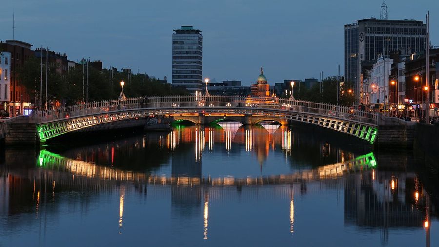 The white cast-iron Ha'penny Bridge arching over the River Liffey in central Dublin