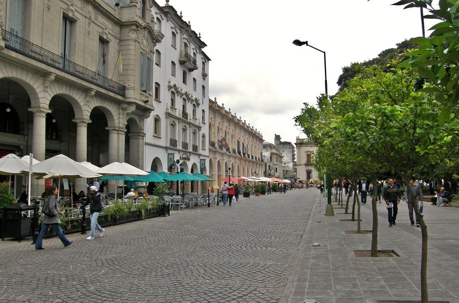 Plaza 9 de Julio, the palm-lined colonial main square of Salta, Argentina, ringed by whitewashed arcaded buildings