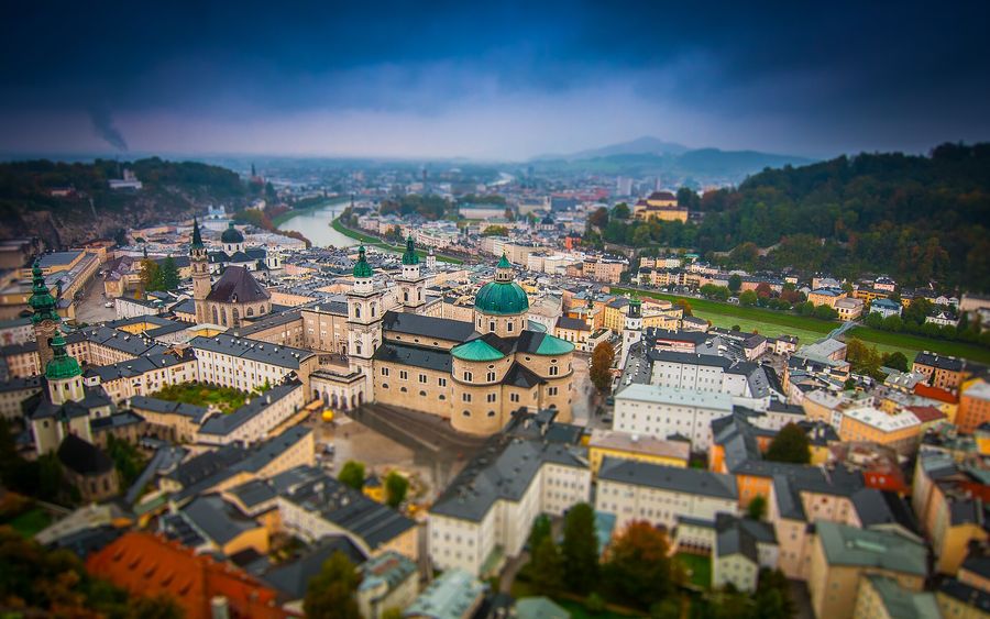 Rooftop view from Hohensalzburg Fortress over Salzburg's baroque domes and spires, with the Salzach River and Kapuzinerberg