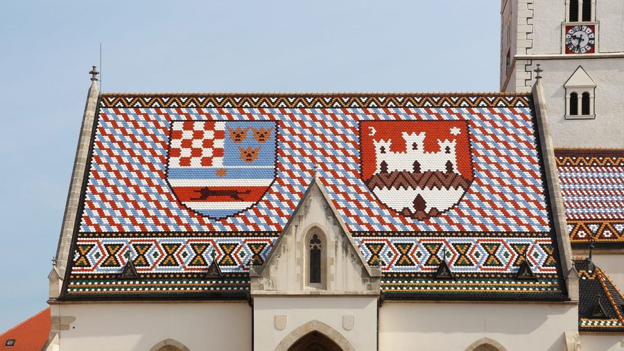 The colourful glazed-tile roof of St Mark's Church in Zagreb's Upper Town, showing the medieval coats of arms of Croatia, Dalmatia and Slavonia beside the emblem of the city of Zagreb